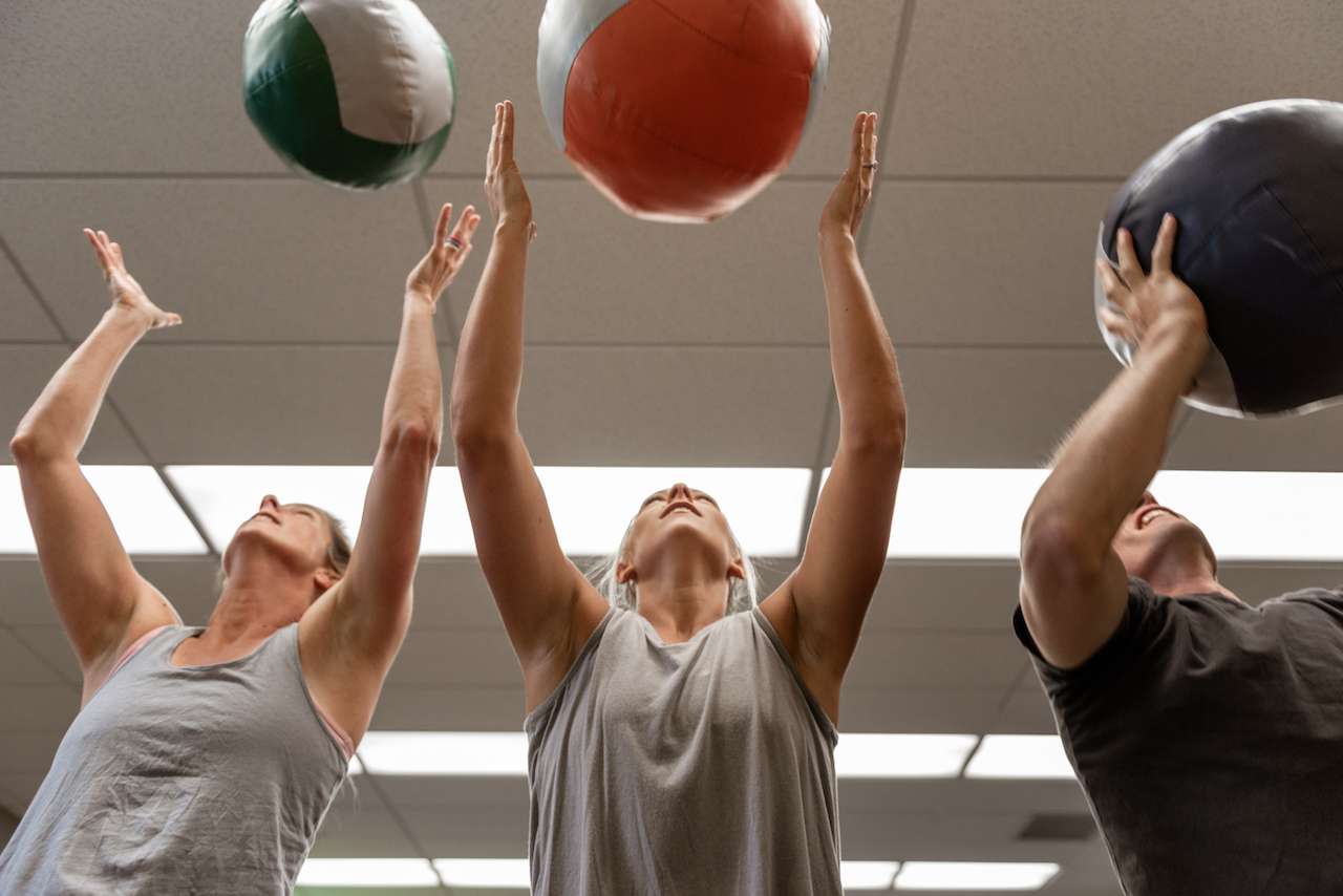 group of people working with medicine balls