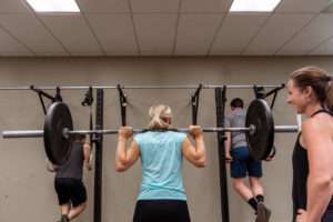 woman performing a squat with a barbell
