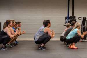 group workout class performing squats
