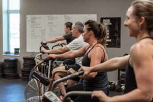fitness class working on exercise bikes