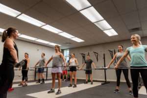 group of people doing weight training