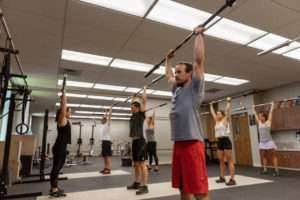 whole exercise class performing weight training
