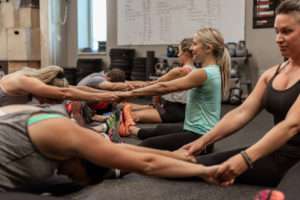 people in an exercise class stretching