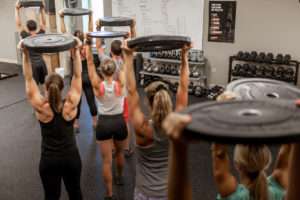 fitness class working with weighted plates