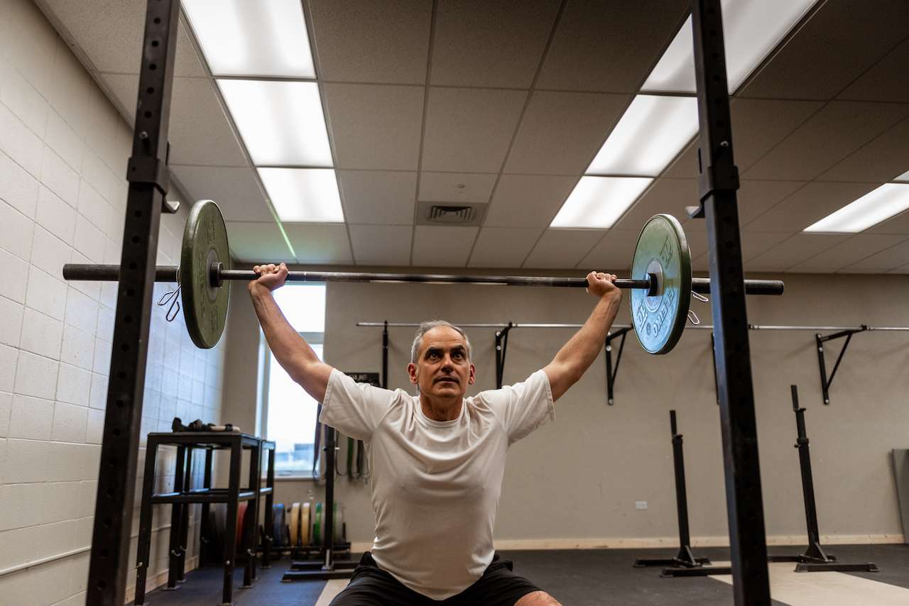 man doing weight training with a barbell